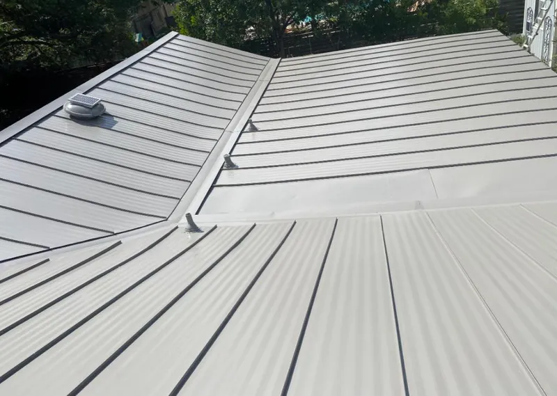 Solar attic fan installed on a metal roof for Roof Ventilation in West University Place