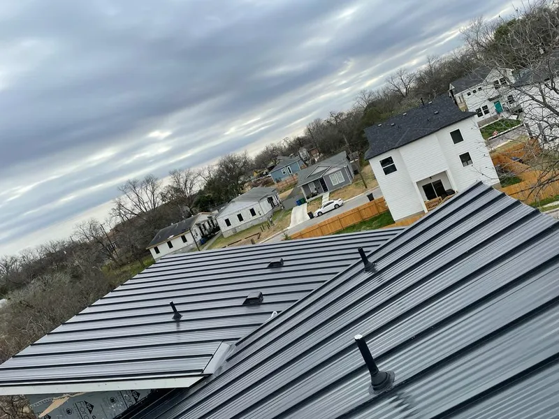 Standing seam metal roof panels with vents for Skylight Repair in West University Place